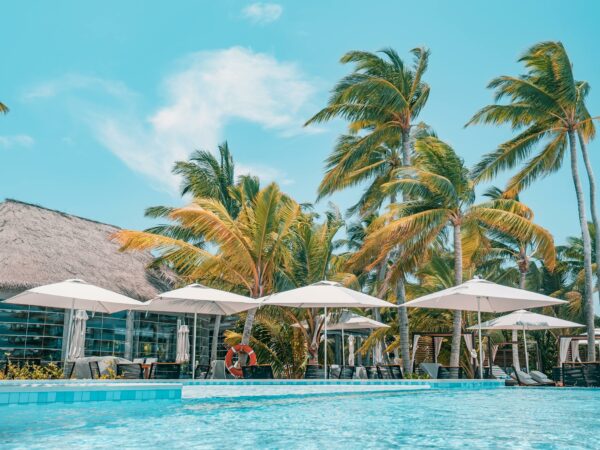 Tropical resort poolside in sunlight